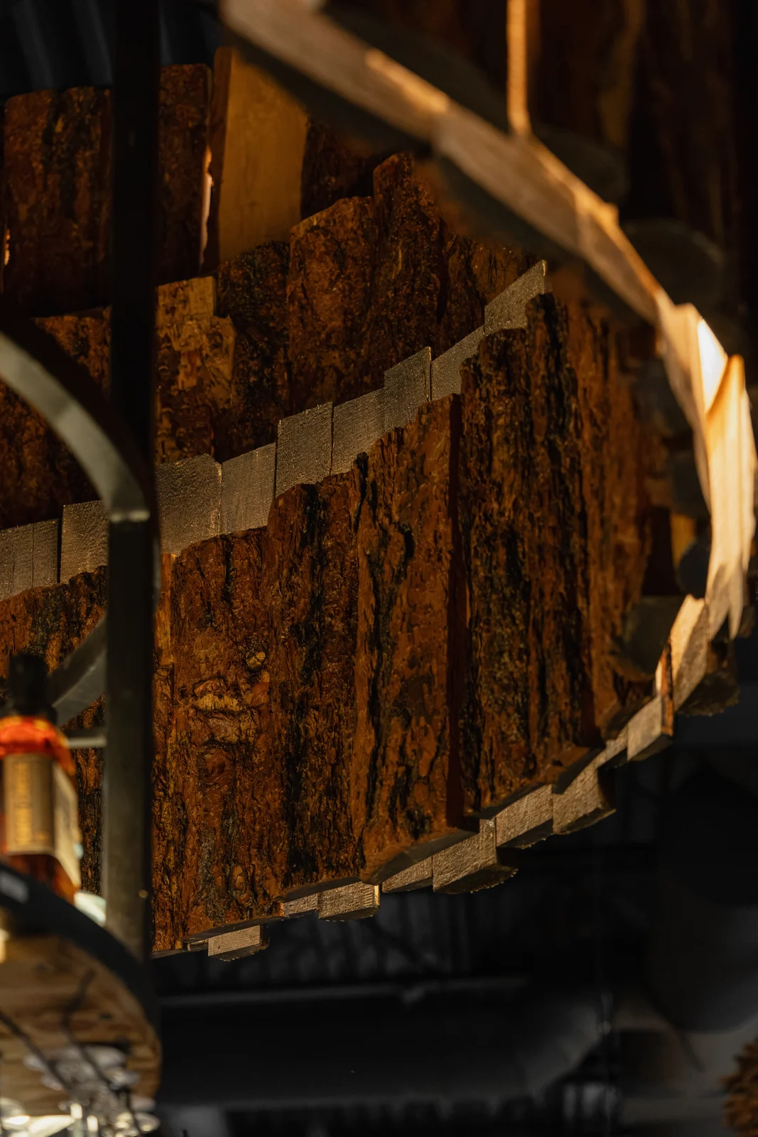 Origen’s sculptural chandelier made from warm timber and bark